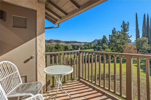 a view of a balcony with chair and wooden floor
