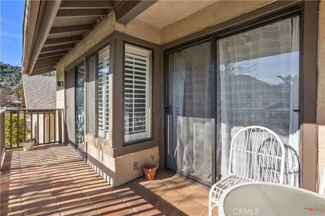a view of a balcony with wooden floor