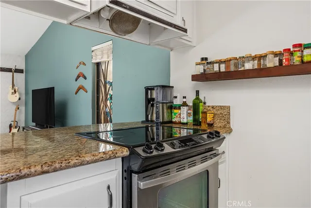 a kitchen with stainless steel appliances granite countertop a sink and cabinets