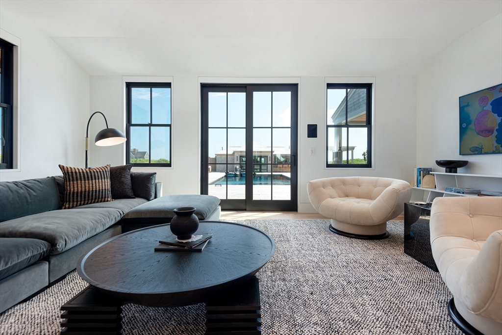 30 Devon Street, Unit THE DIPS Nantucket, MA 02554 - Photo 16 of 42 a living room with furniture a rug a lamp and a potted plant