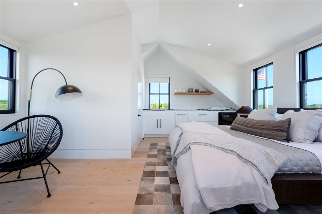 30 Devon Street, Unit THE DIPS Nantucket, MA 02554 - Photo 18 of 42 a bed room with a bed and a chair