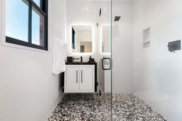 a bathroom with a sink a toilet and shower