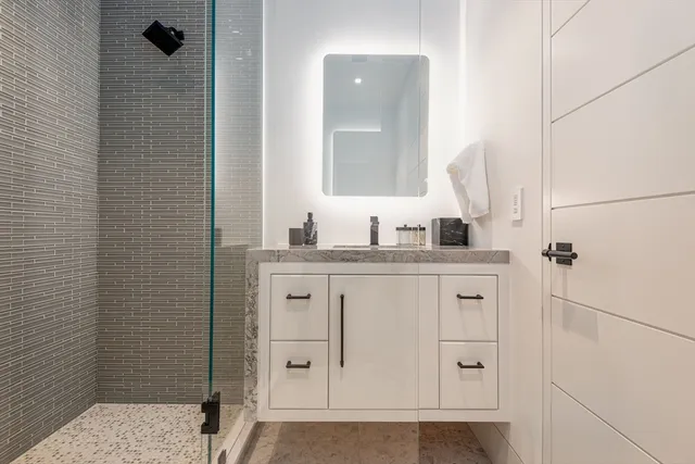 an aerial view of residential houses with outdoor space and city view