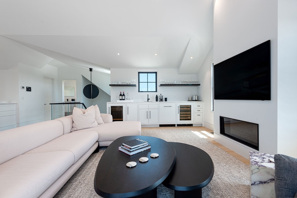 30 Devon Street, Unit THE DIPS Nantucket, MA 02554 - Photo 38 of 42 a living room with furniture and a flat screen tv