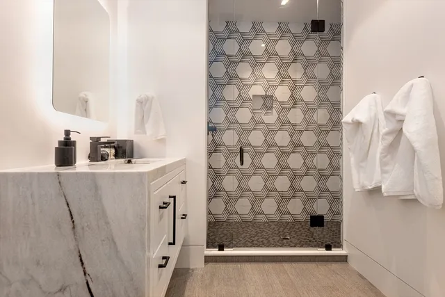 a large bed sitting in a bedroom next to a window