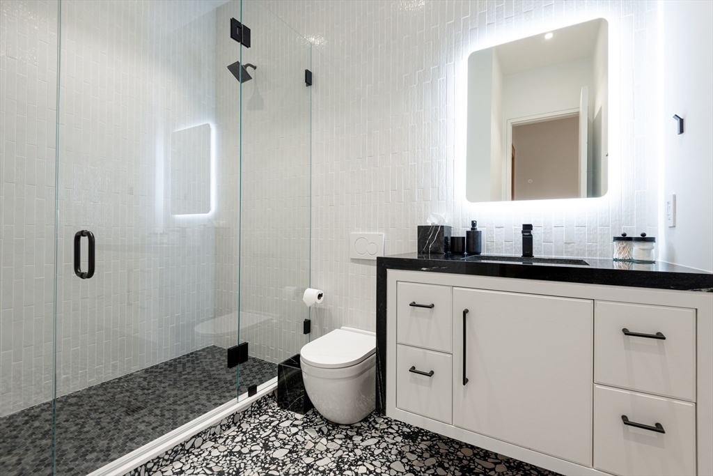 30 Devon Street, Unit THE DIPS Nantucket, MA 02554 - Photo 7 of 42 a bathroom with a sink a toilet and shower