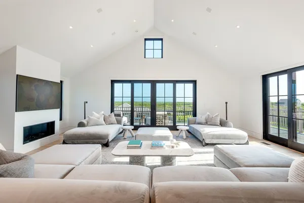a living room with furniture and paintings on the wall