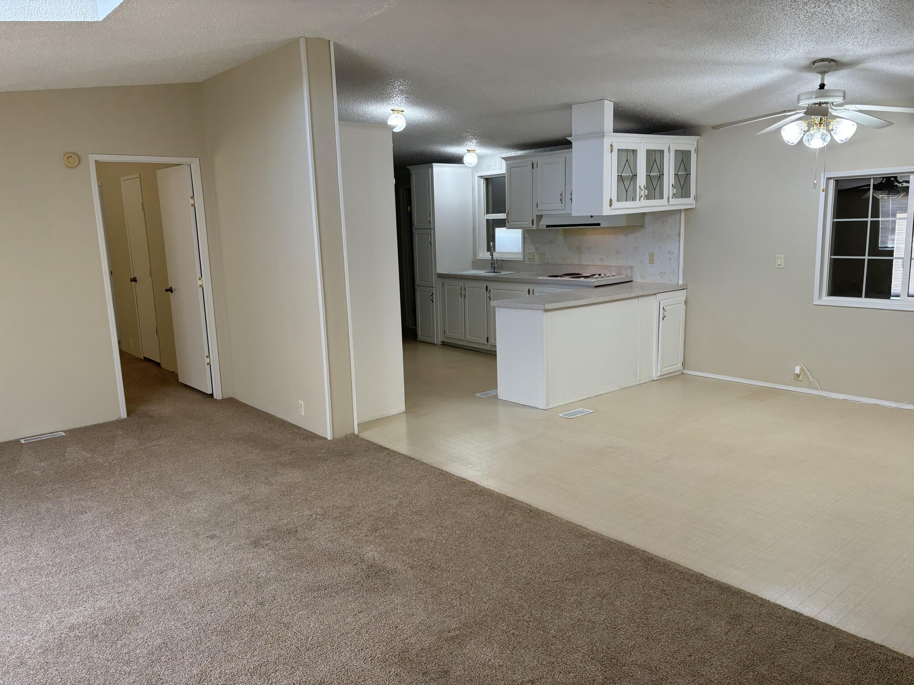 9073 Hull Street Mojave, CA 93501 - Photo 11 of 16 a view of kitchen with kitchen island a sink wooden floor and a refrigerator