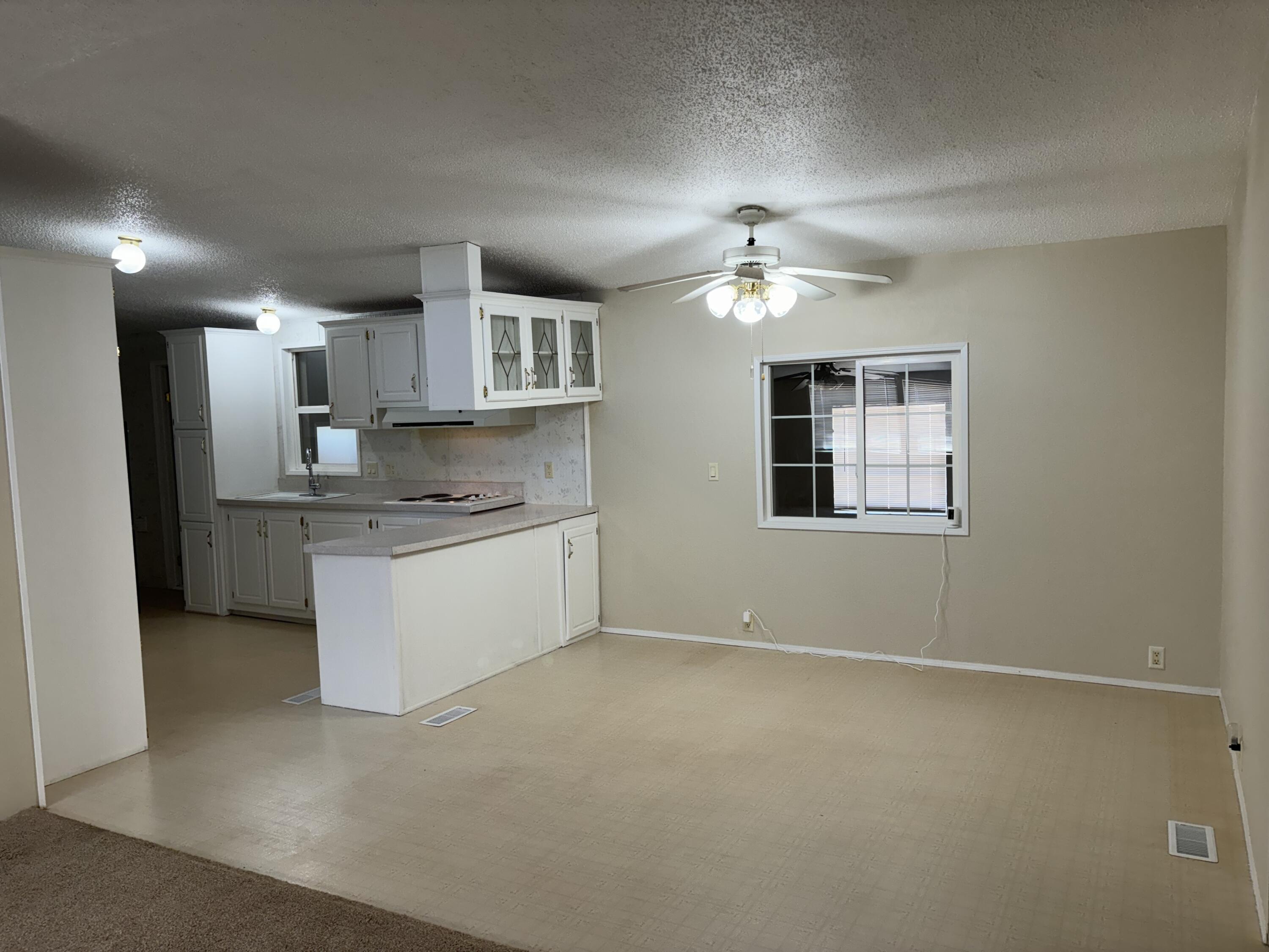 9073 Hull Street Mojave, CA 93501 - Photo 12 of 16 a kitchen with a refrigerator sink and cabinets