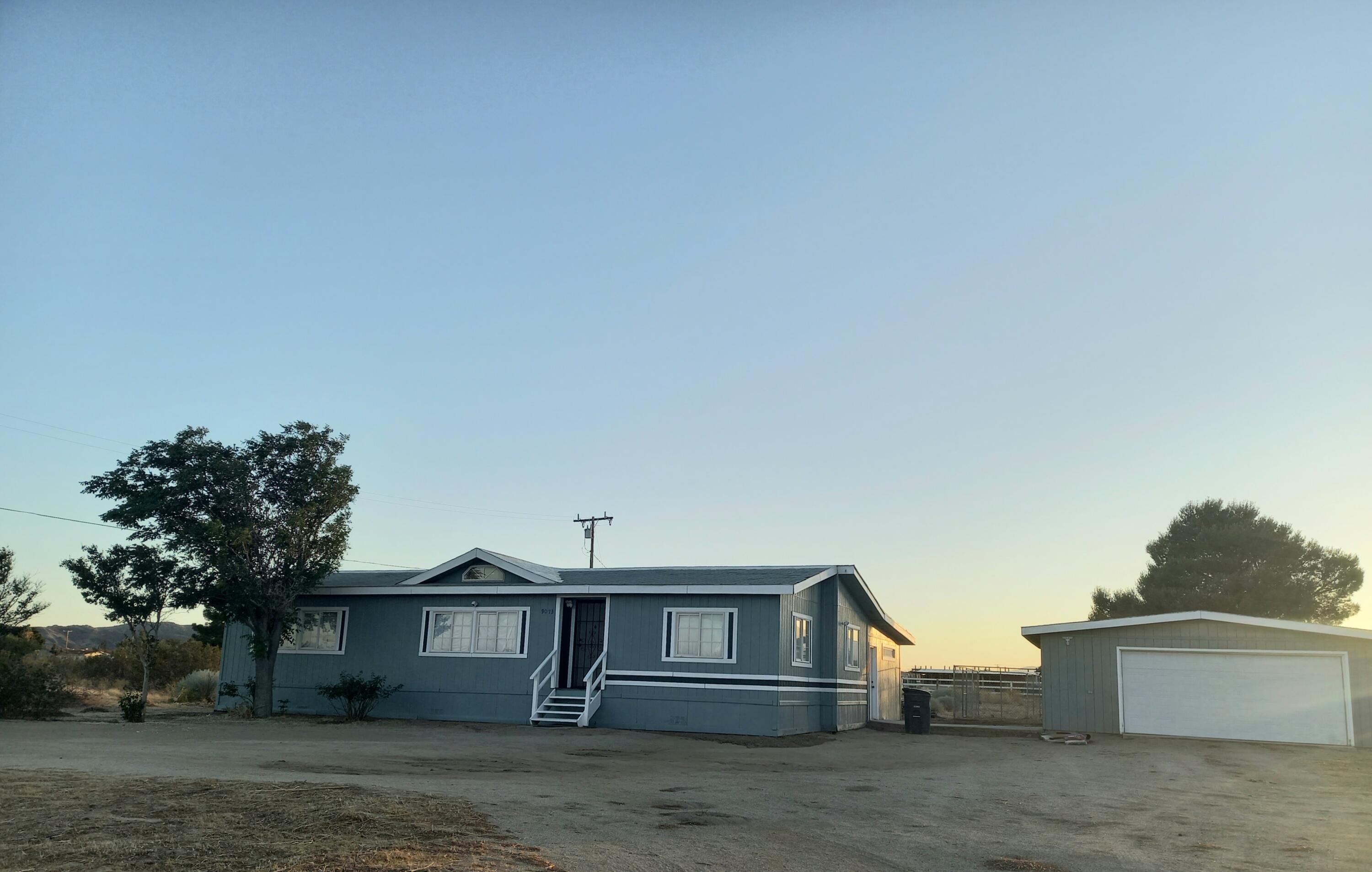 9073 Hull Street Mojave, CA 93501 - Photo 2 of 16 a front view of a house with a yard
