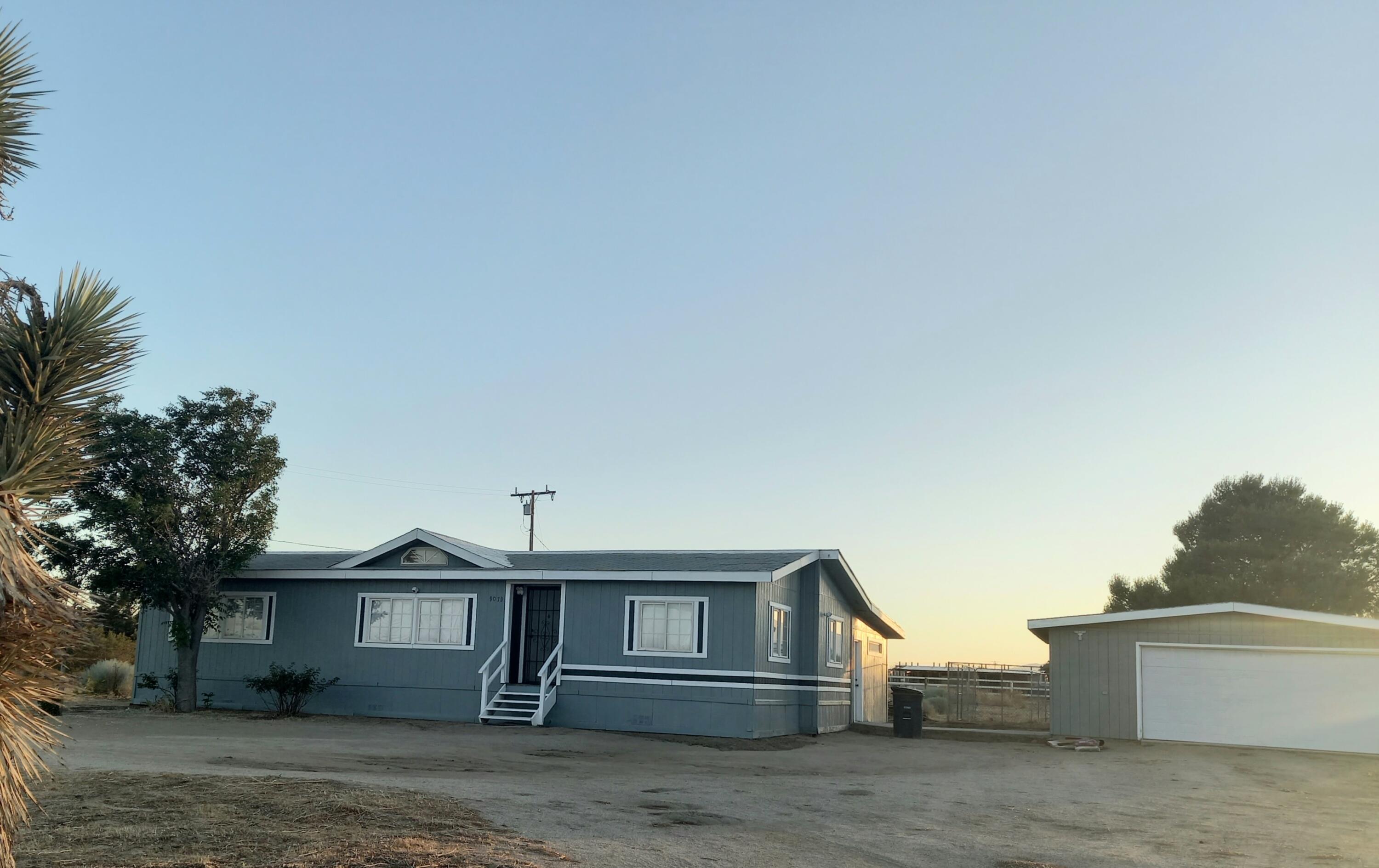 9073 Hull Street Mojave, CA 93501 - Photo 3 of 16 a front view of a house with garage