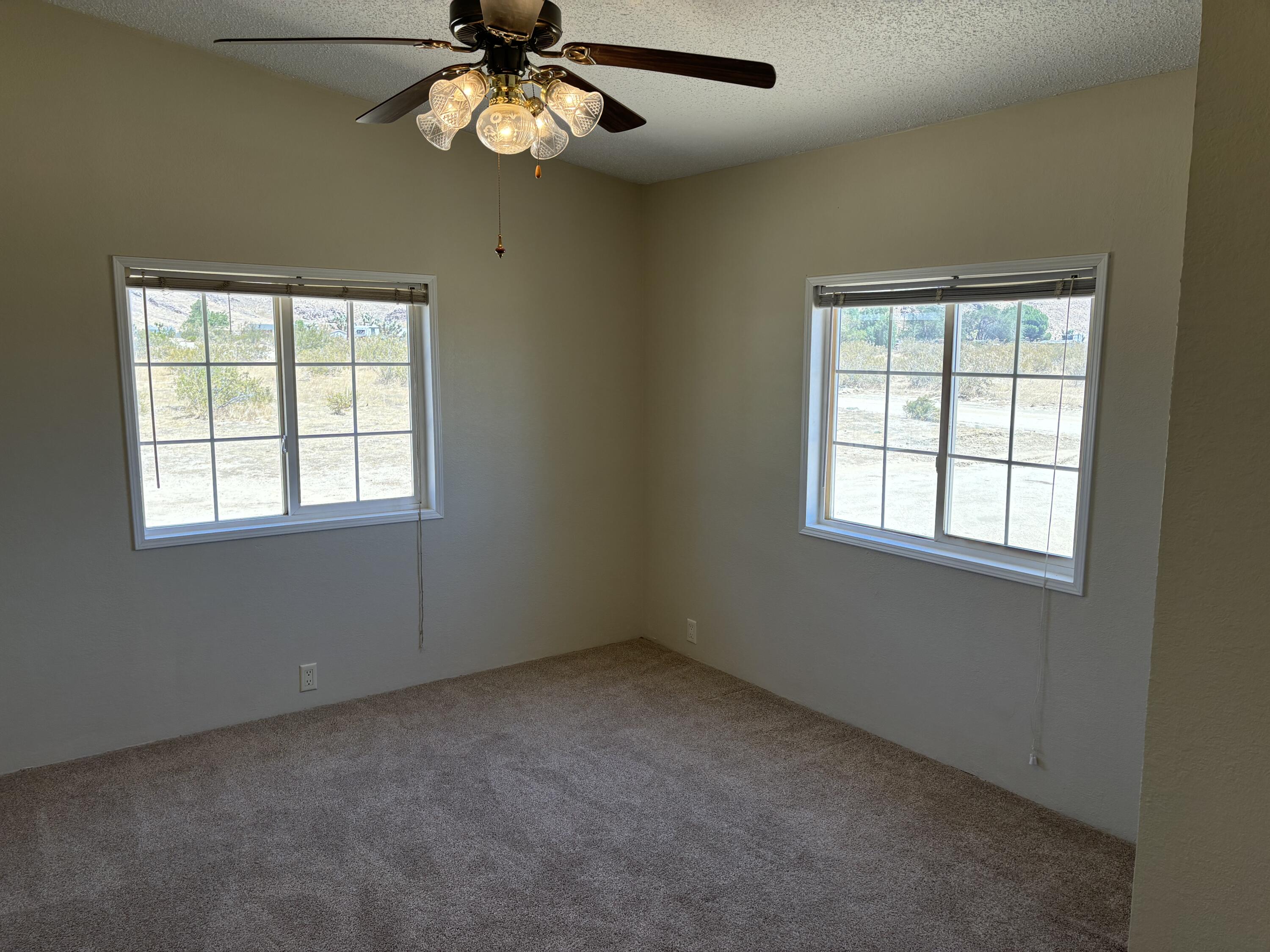 9073 Hull Street Mojave, CA 93501 - Photo 5 of 16 an empty room with a window