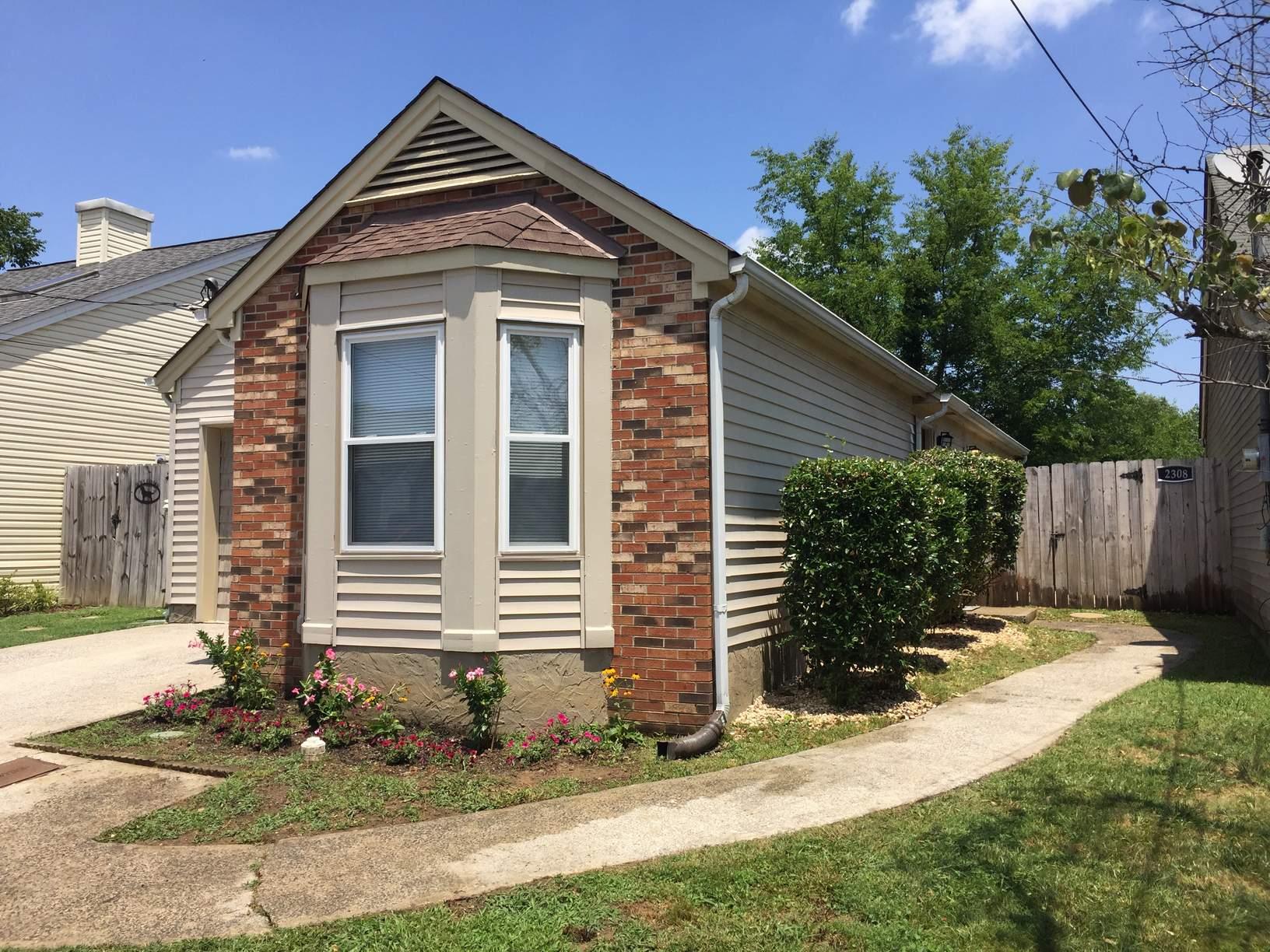 2308 Benay Road Nashville, TN 37214 - Photo 3 of 18 a front view of a house with a yard