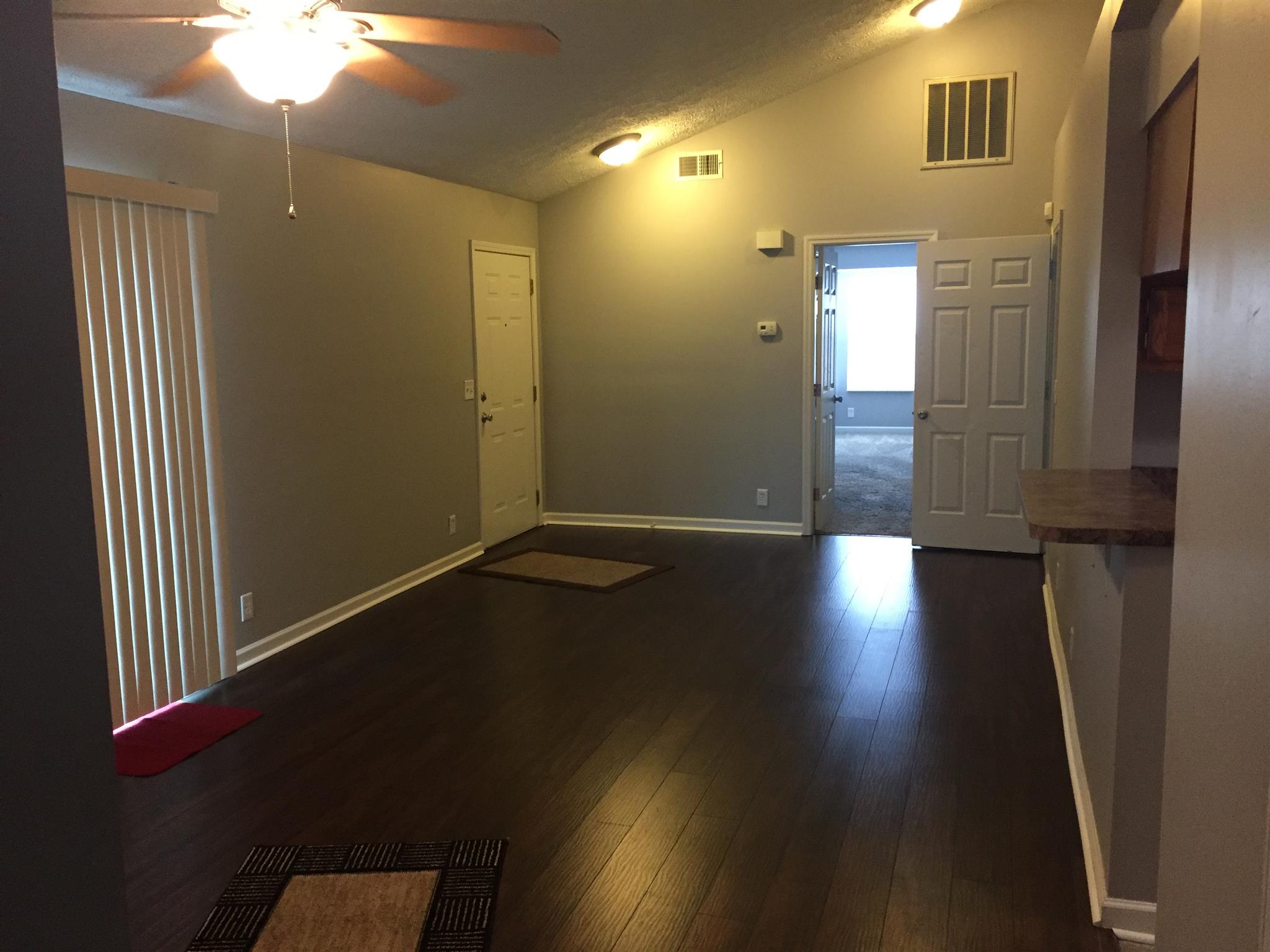 2308 Benay Road Nashville, TN 37214 - Photo 6 of 18 an empty room with wooden floor and windows