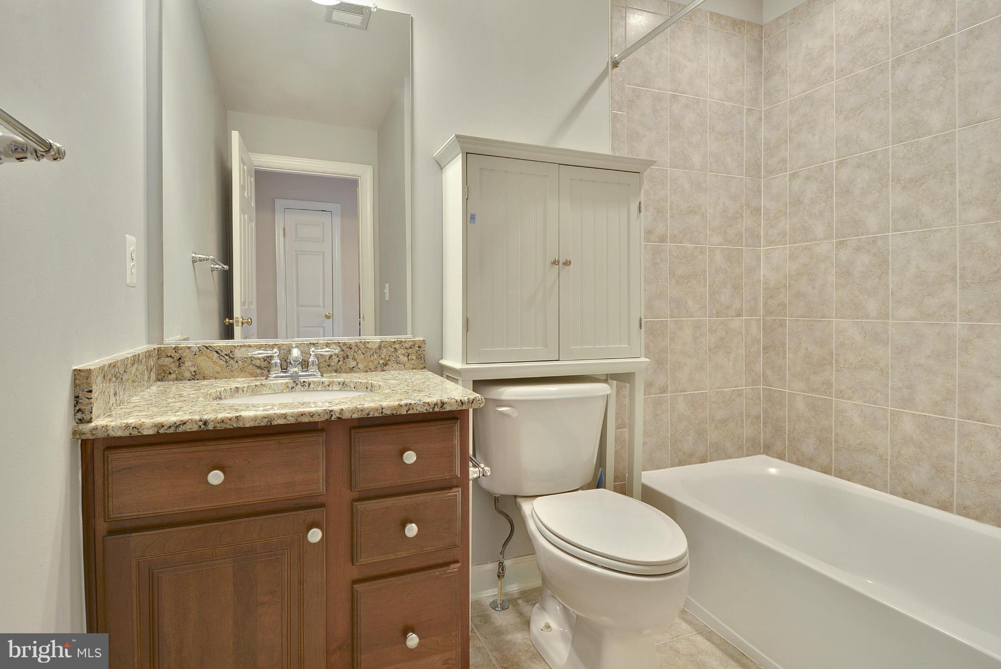 7976 Vigne Court Vienna, VA 22182 - Photo 15 of 30 Upper bath with granite counter and tub.