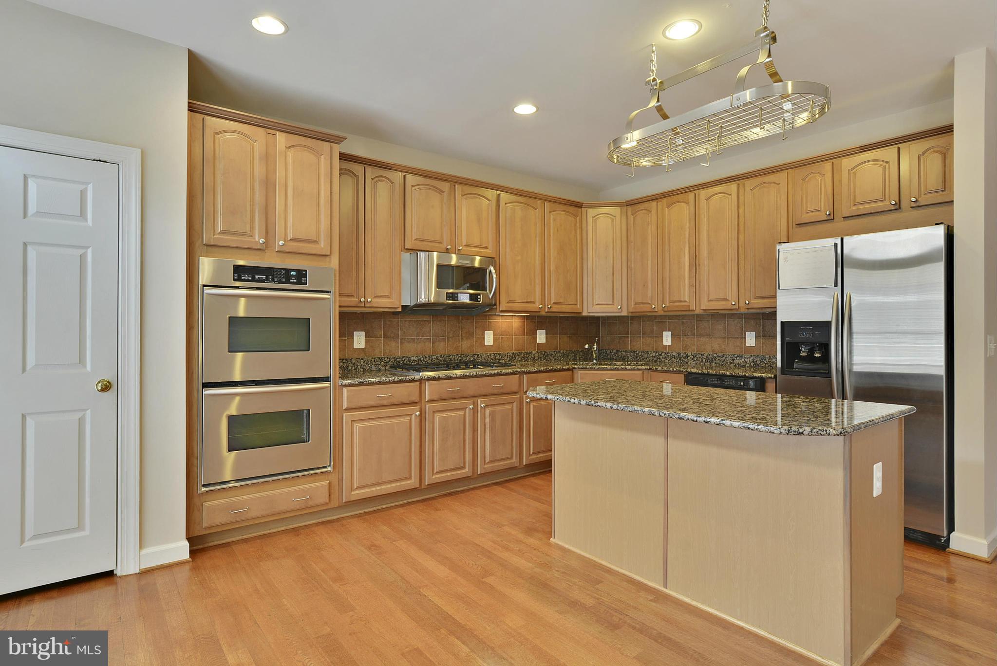 7976 Vigne Court Vienna, VA 22182 - Photo 4 of 30 Double oven and 5-burner gas stove in kitchen.