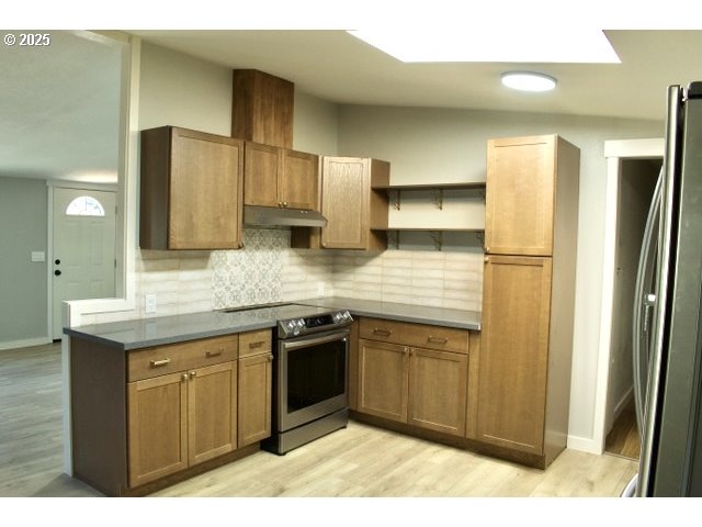 700 Northeast 183rd Avenue, Unit 7 Portland, OR 97230 - Photo 26 of 27 a kitchen with stainless steel appliances granite countertop a sink a stove and a refrigerator