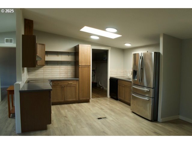 700 Northeast 183rd Avenue, Unit 7 Portland, OR 97230 - Photo 3 of 27 a kitchen with stainless steel appliances kitchen island granite countertop a refrigerator and a sink