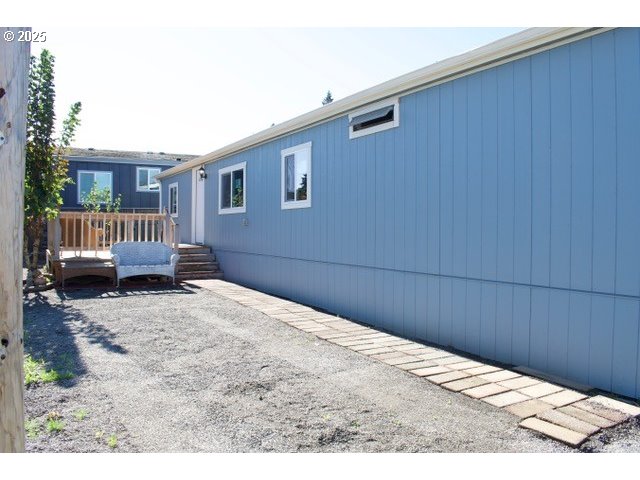 700 Northeast 183rd Avenue, Unit 7 Portland, OR 97230 - Photo 9 of 27 a bedroom with a bed and wooden floor