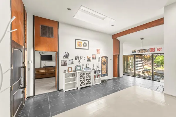 a view of a workspace with furniture and a flat screen tv