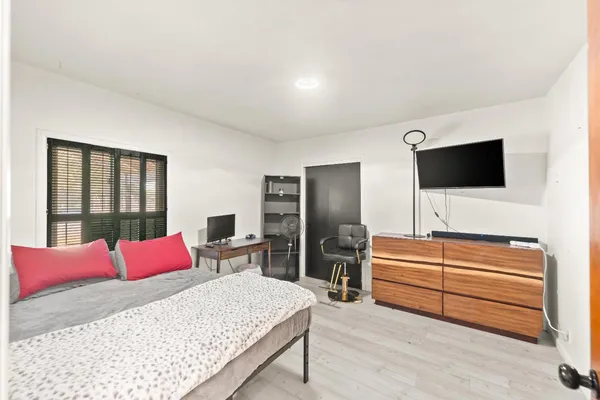 a bedroom with a bed and a dresser
