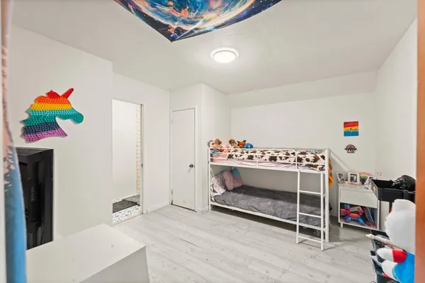 a bedroom with a bed and large window