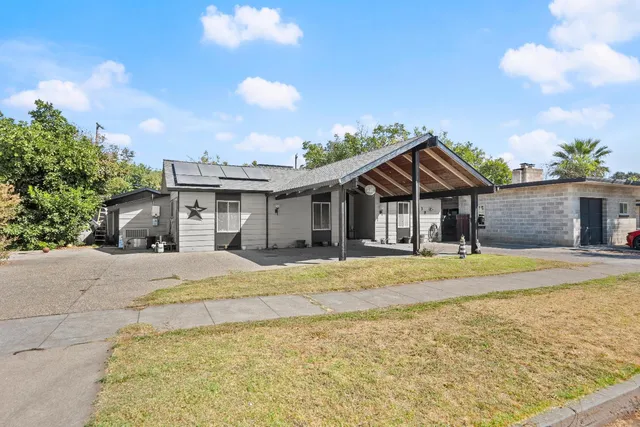 a front view of a house with a garden