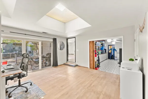 a view of a workspace with furniture and wooden floor