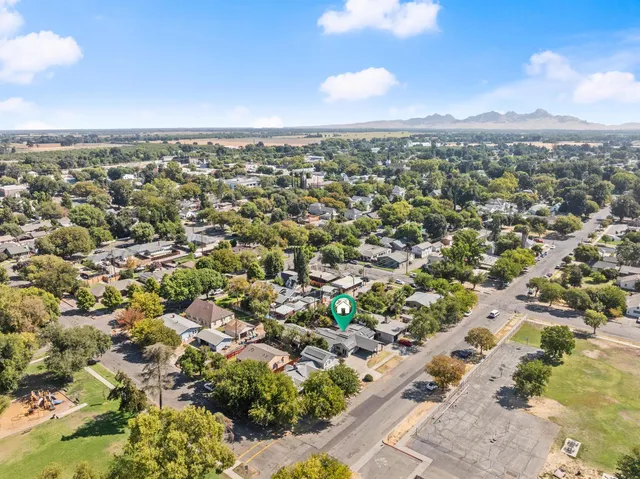 an aerial view of residential houses with outdoor space