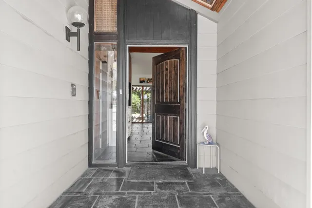 a view of a livingroom with workspace and a window