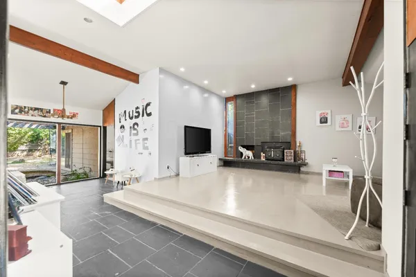 a view of a livingroom with furniture and a flat screen tv