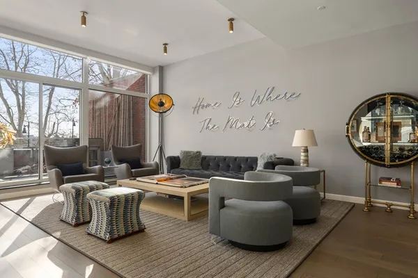 a living room with furniture a rug and a large window