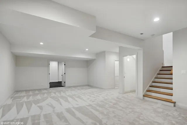 a large kitchen with stainless steel appliances a large counter top a sink a stove and a refrigerator