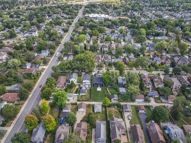an aerial view of residential houses with outdoor space and street view