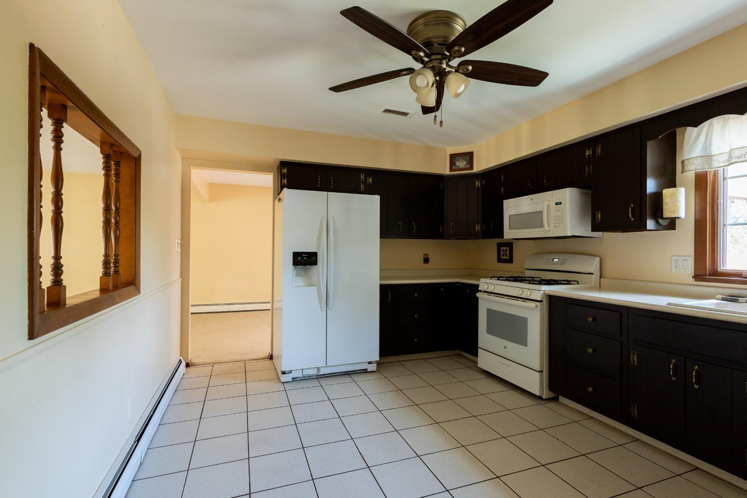 934 West Pine Street Griffith, IN 46319 - Photo 4 of 12 a kitchen with stainless steel appliances granite countertop a refrigerator and a sink