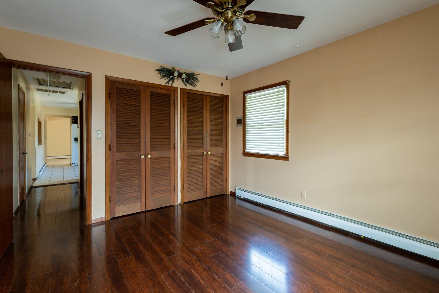 934 West Pine Street Griffith, IN 46319 - Photo 5 of 12 an empty room with wooden floor closet and windows