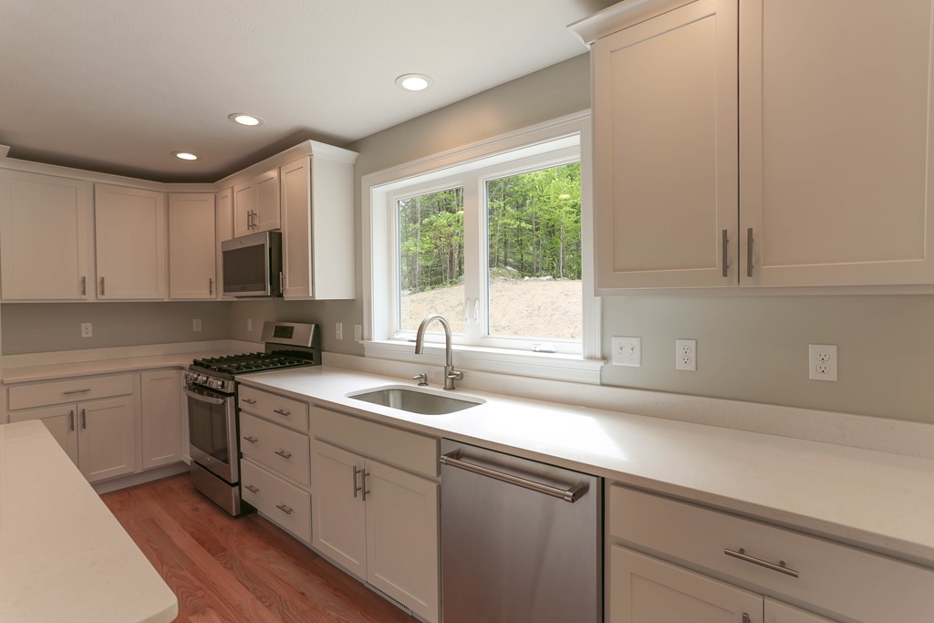 14 Spring Street Hopkinton, MA 01748 - Photo 4 of 16 a kitchen with a sink cabinets stainless steel appliances and a window