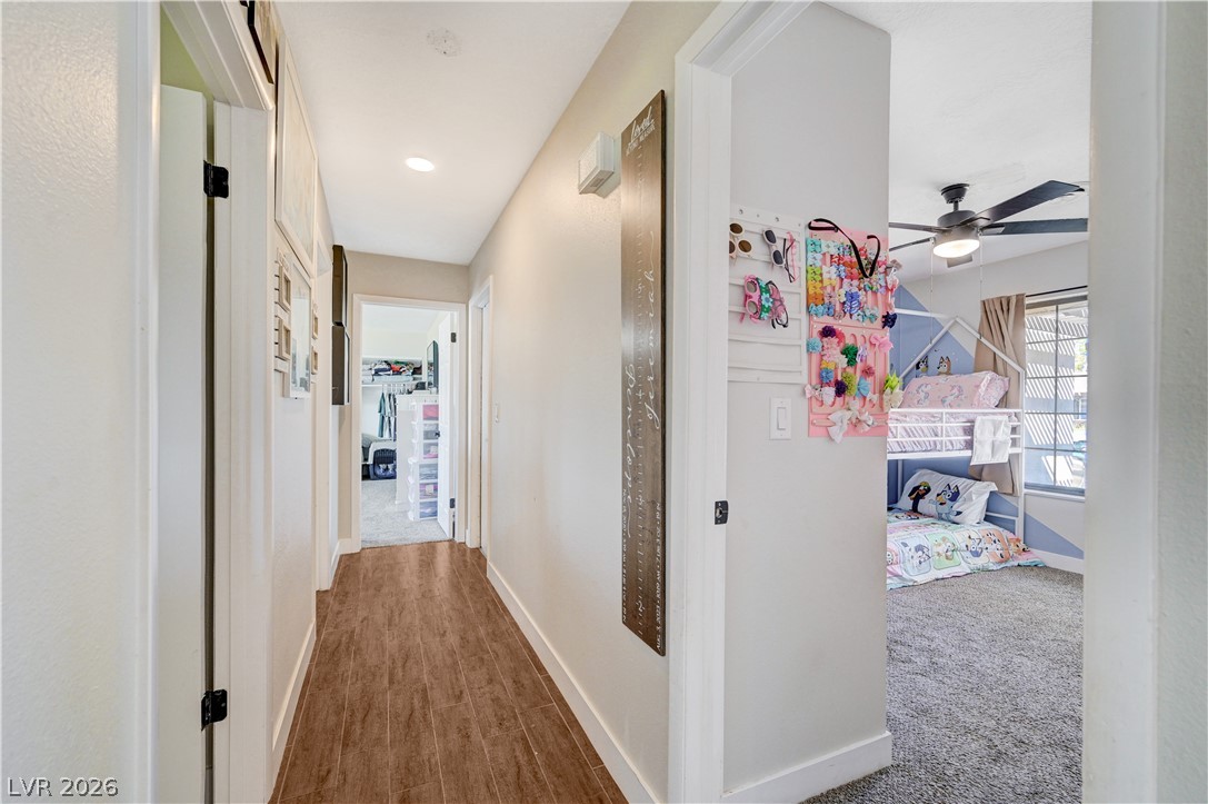 1331 Pinto Road Boulder City, NV 89005 - Photo 23 of 46 A welcoming hallway connects living spaces, featuring resilient wood-look tile flooring.