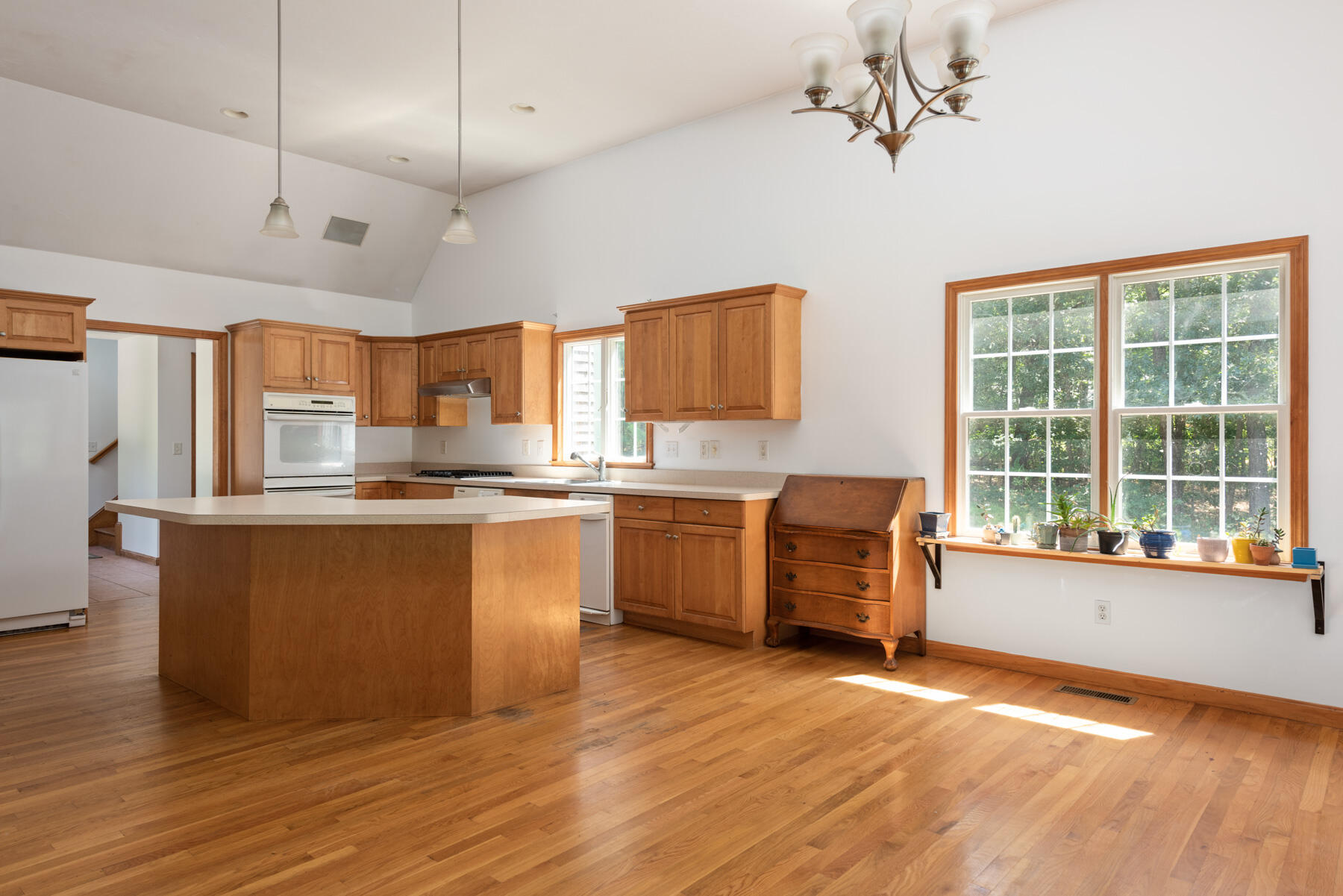 25 Gilbert Lane Harwich Port, MA 02646 - Photo 15 of 25 a kitchen with granite countertop wooden floors and white stainless steel appliances