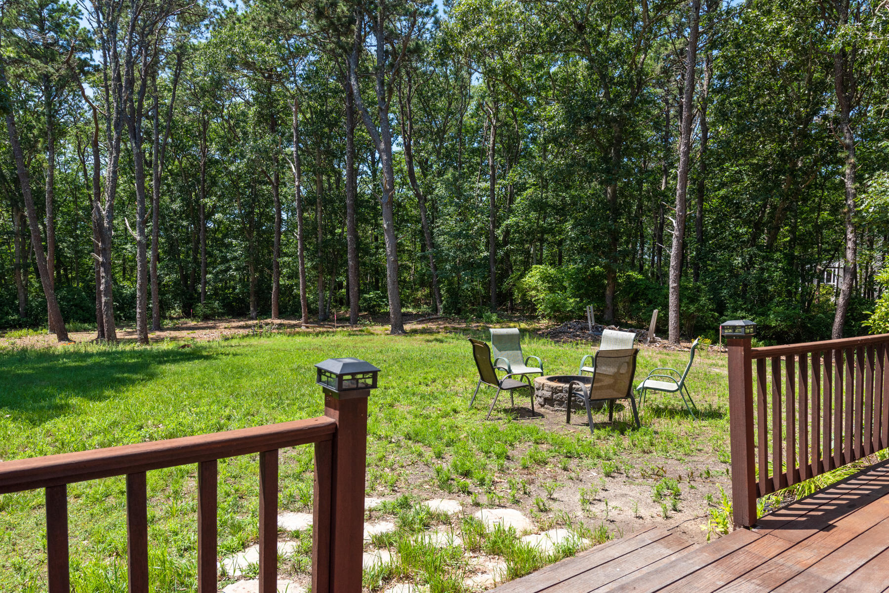 25 Gilbert Lane Harwich Port, MA 02646 - Photo 6 of 25 a view of a bench in a backyard