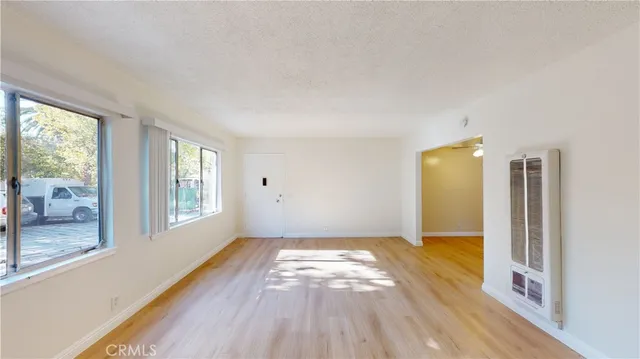 a kitchen with a refrigerator and a stove top oven