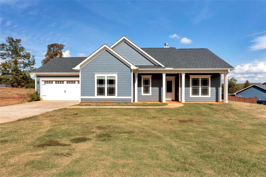 a front view of a house with a garden