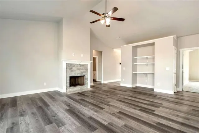 a view of a livingroom with a fireplace a chandelier and stairs