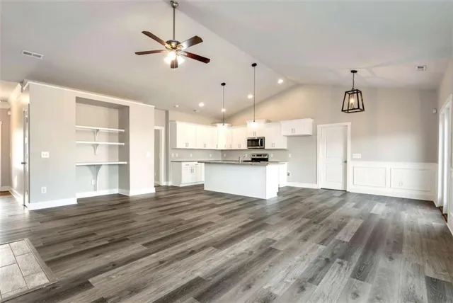 a view of kitchen with stove and wooden floor