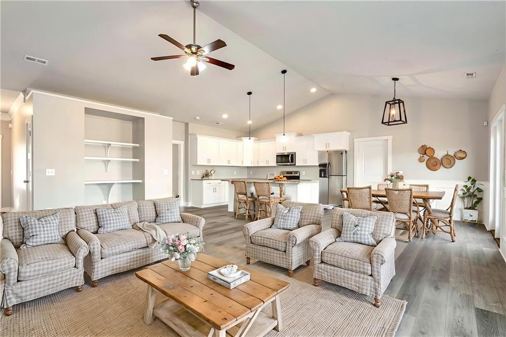 482 North Point Circle Hartwell, GA 30643 - Photo 13 of 32 a living room with furniture kitchen view and a chandelier
