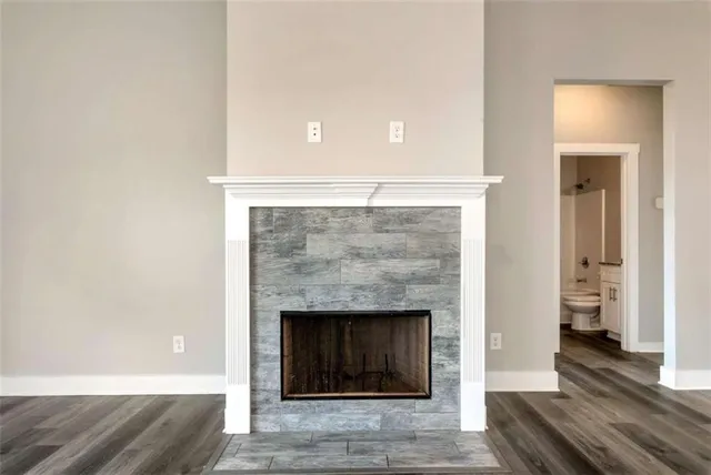 a living room with a fireplace and wooden floor