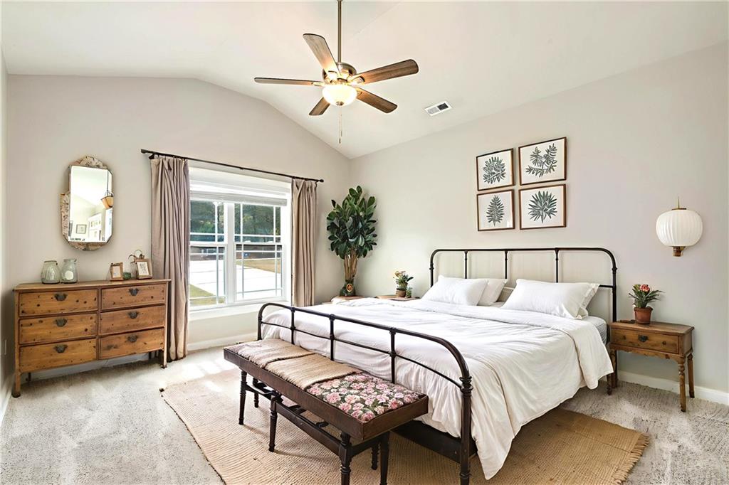 482 North Point Circle Hartwell, GA 30643 - Photo 23 of 32 a bedroom with a large bed and a chandelier