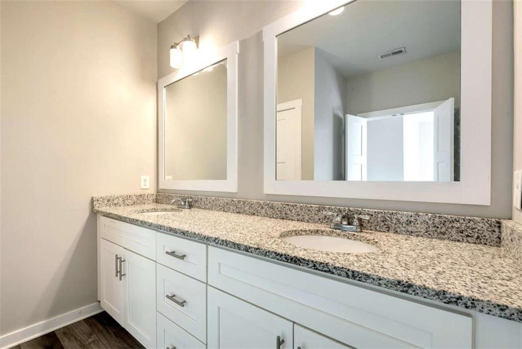 482 North Point Circle Hartwell, GA 30643 - Photo 25 of 32 a bathroom with a granite countertop sink and a mirror