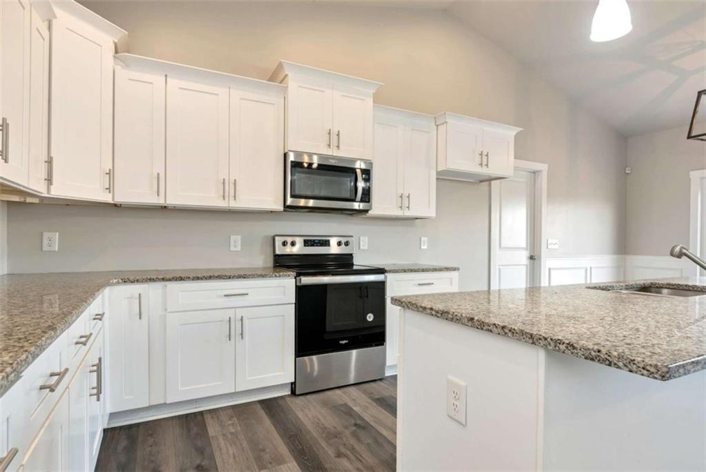 482 North Point Circle Hartwell, GA 30643 - Photo 9 of 32 a kitchen with granite countertop a sink a stove and cabinets