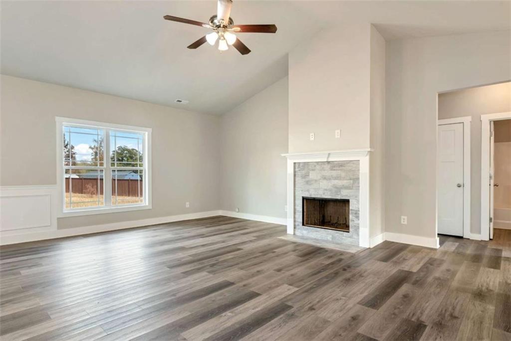 482 North Point Circle Hartwell, GA 30643 - Photo 10 of 32 a view of an empty room with wooden floor fireplace and a window